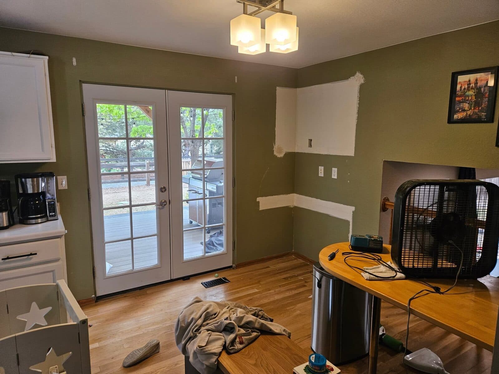 Room with olive-green painted walls and French doors