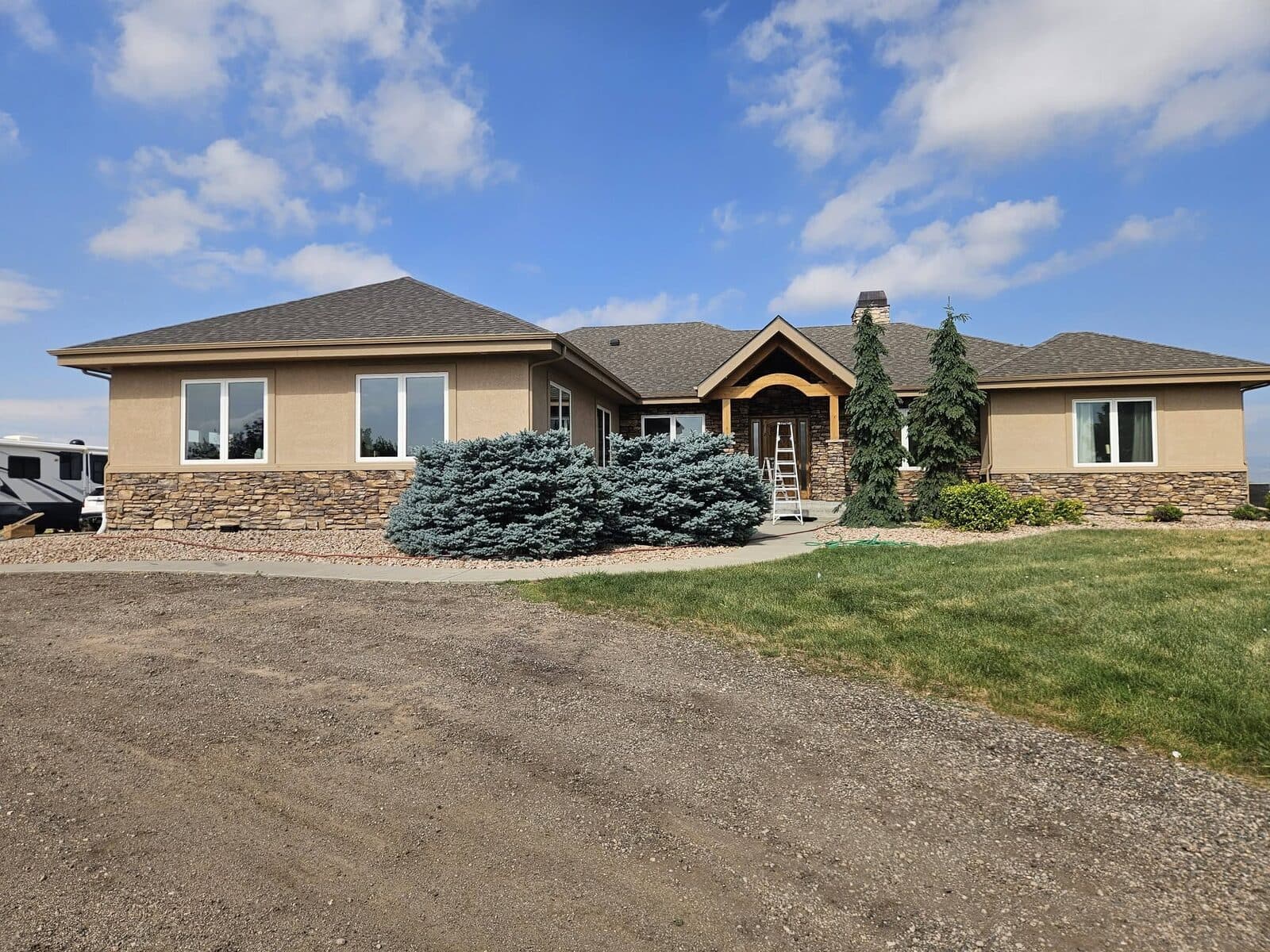 Stone and stucco ranch home with landscaping