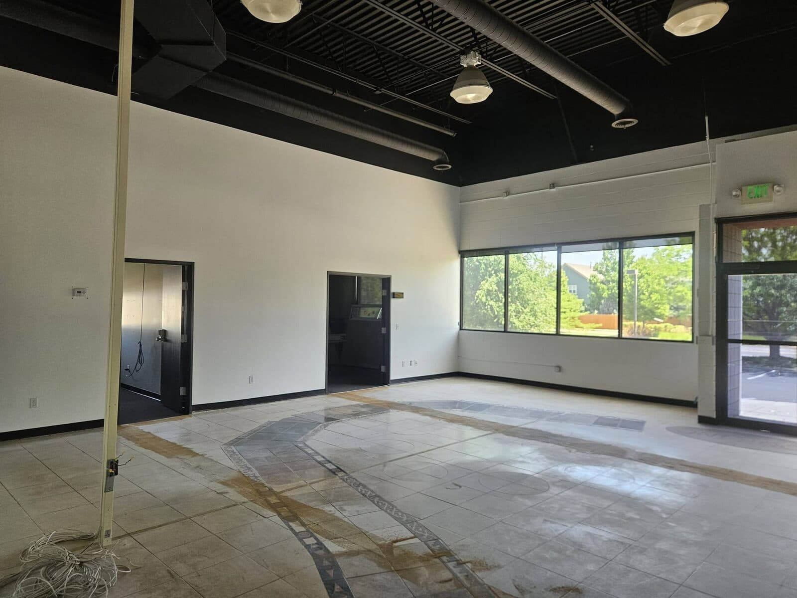 Finished commercial space with white walls and black ceiling
