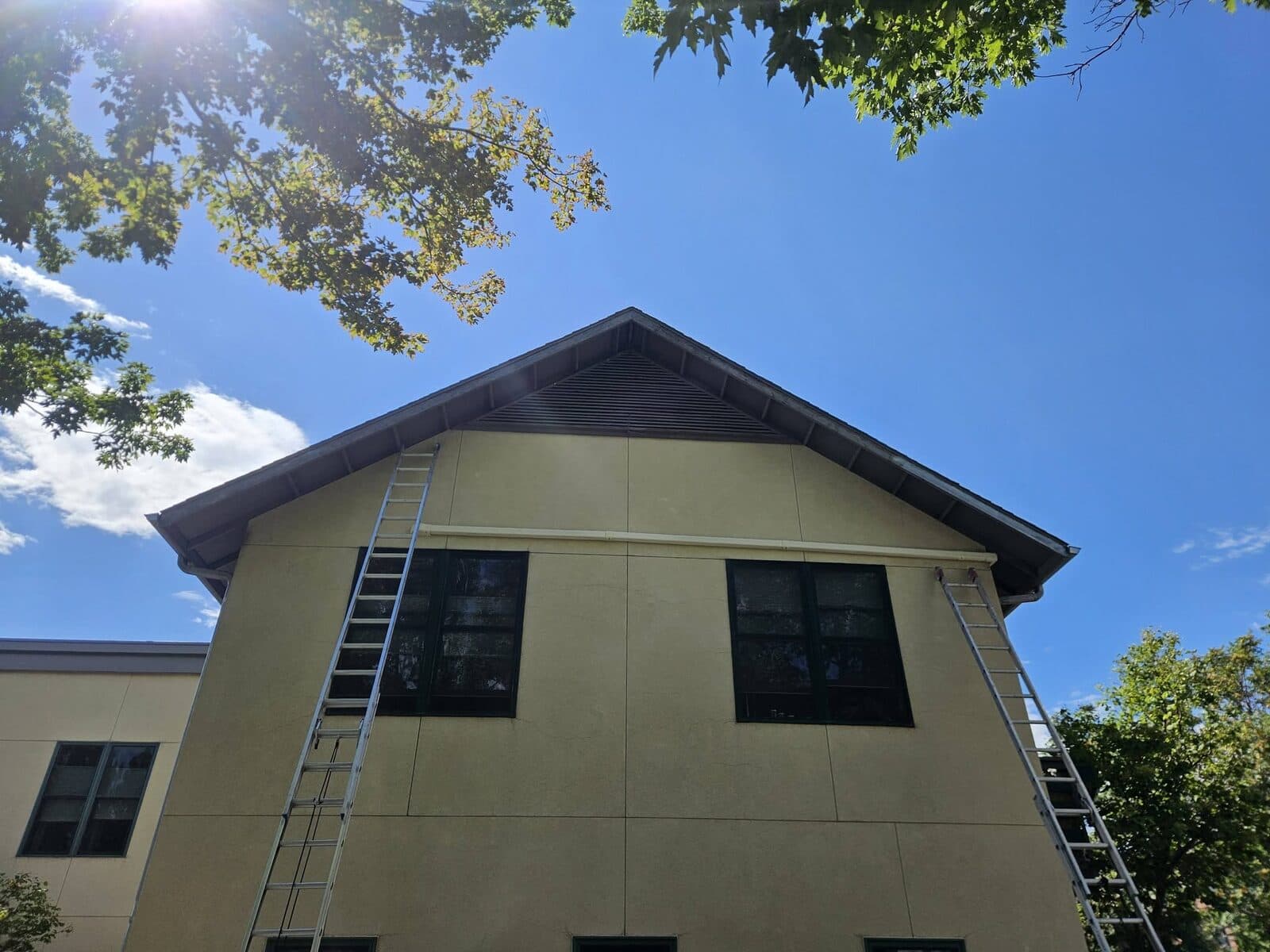 Exterior painting underway on a two-story home